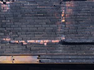 Brick wall damaged by the fire and smoke.