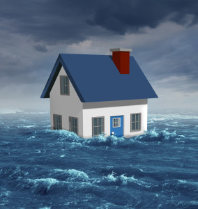 House floating away in flood.