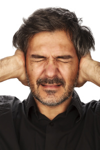 Man covering his ears about the things he doesn't wanna hear about property damage repairs.