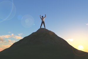 Topless man on top of a mountain on a bright morning sunshine.bright